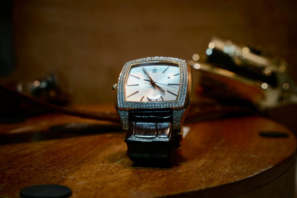 a watch sitting on top of a wooden table